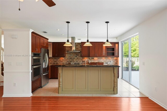 kitchen featuring sink, a center island with sink, light tile patterned floors, dishwasher, and ceiling fan