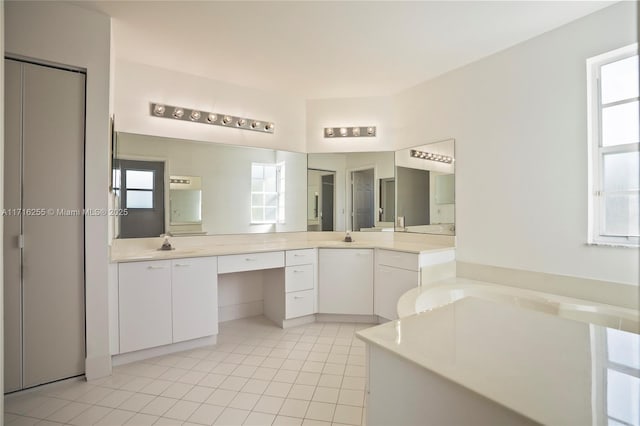 bathroom with tile patterned floors, vanity, and a bathing tub