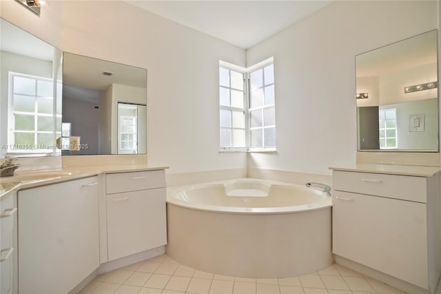 bathroom featuring vanity, a bath, and tile patterned floors