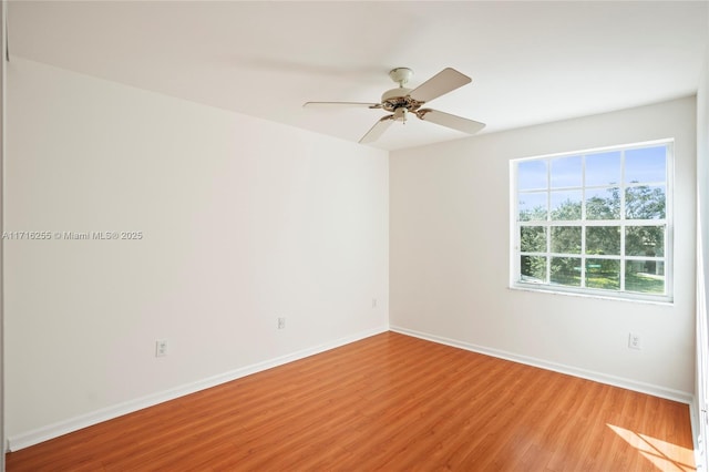 empty room featuring ceiling fan and light hardwood / wood-style floors