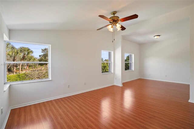 unfurnished room featuring ceiling fan, vaulted ceiling, and wood-type flooring