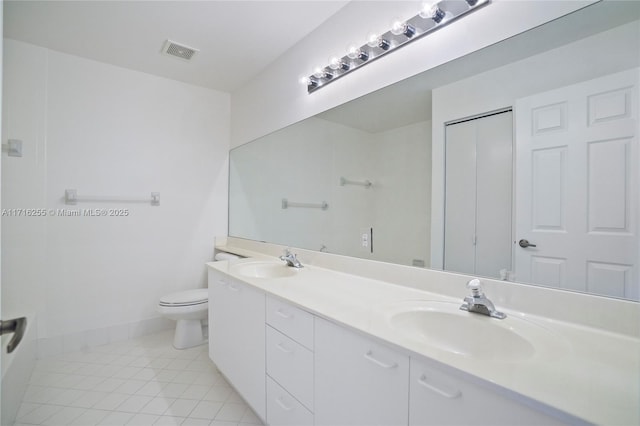 bathroom featuring tile patterned floors, vanity, and toilet