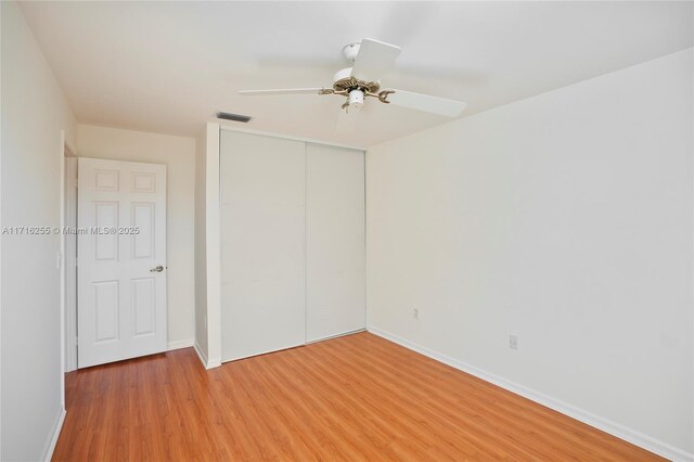 spare room with ceiling fan and light hardwood / wood-style floors