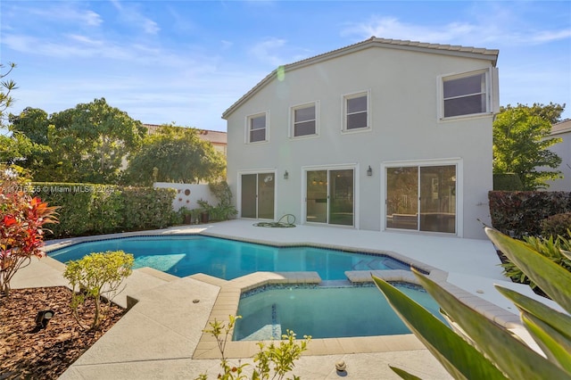 view of pool featuring an in ground hot tub and a patio