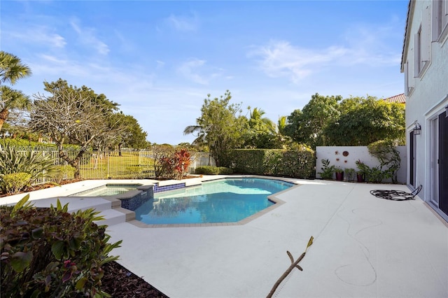 view of swimming pool with a patio and an in ground hot tub