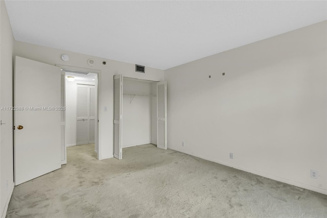 unfurnished bedroom with light colored carpet