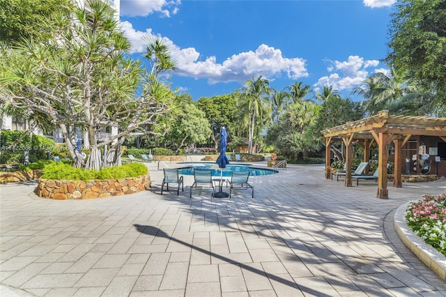 surrounding community featuring a pergola, a swimming pool, and a patio