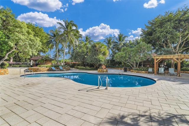 view of pool with a pergola and a patio area