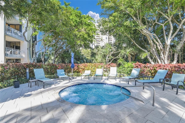 view of pool with an in ground hot tub and a patio