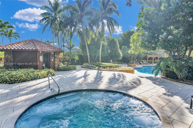 view of swimming pool with an in ground hot tub and a patio