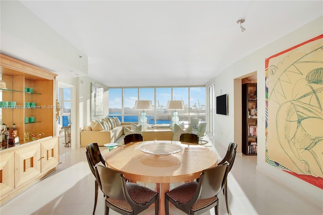 tiled dining area with expansive windows