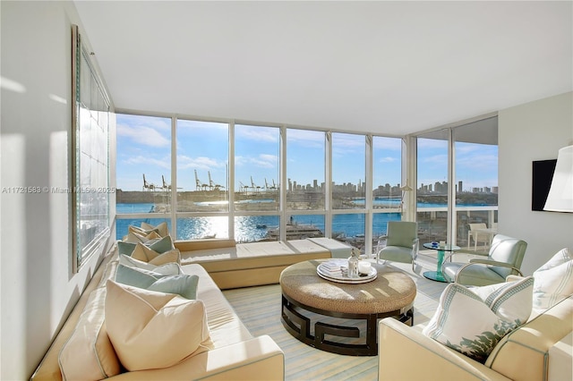 sunroom featuring a water view