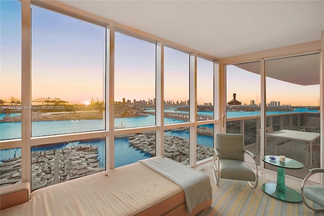 sunroom / solarium featuring a water view