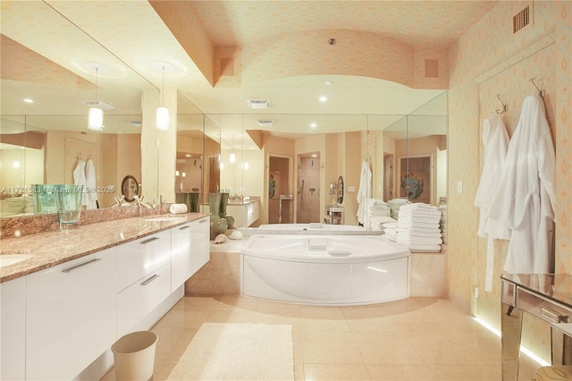 bathroom with tile patterned floors, vanity, vaulted ceiling, a bath, and toilet