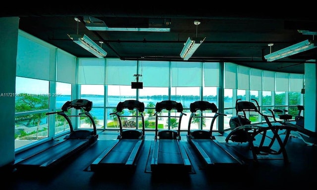 workout area featuring a water view