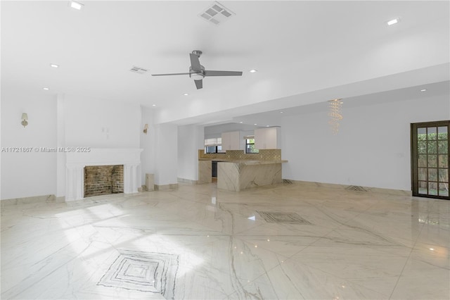 unfurnished living room with ceiling fan