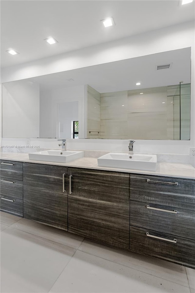 bathroom featuring vanity, tile patterned floors, and walk in shower