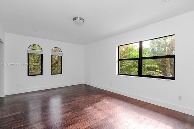 unfurnished room featuring dark hardwood / wood-style floors