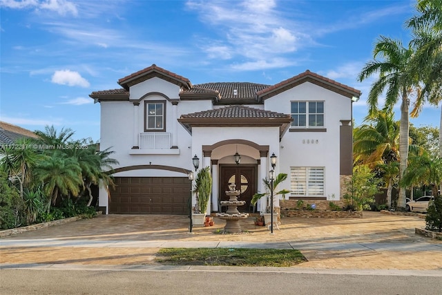 mediterranean / spanish home with a garage