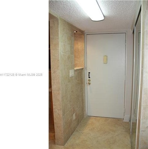 hallway featuring a textured ceiling