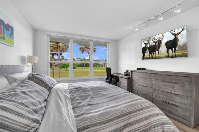 bedroom featuring track lighting