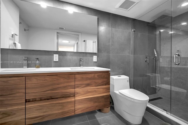 bathroom with walk in shower, backsplash, tile patterned floors, toilet, and tile walls