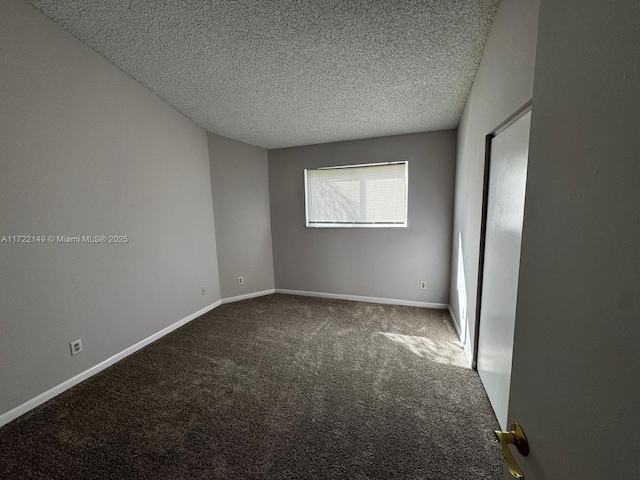 carpeted spare room with a textured ceiling