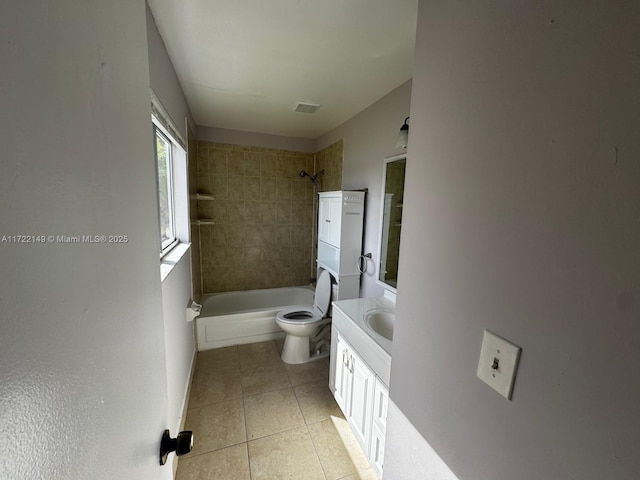 full bathroom featuring tile patterned floors, vanity, toilet, and tiled shower / bath