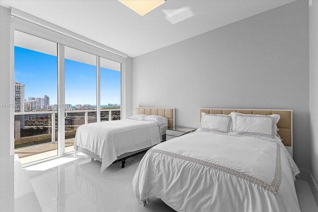 bedroom with access to outside, expansive windows, and light tile patterned floors