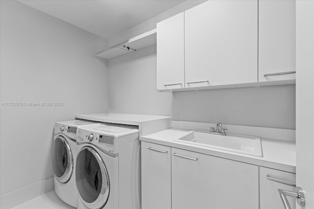 laundry area featuring cabinets, independent washer and dryer, tile patterned floors, and sink