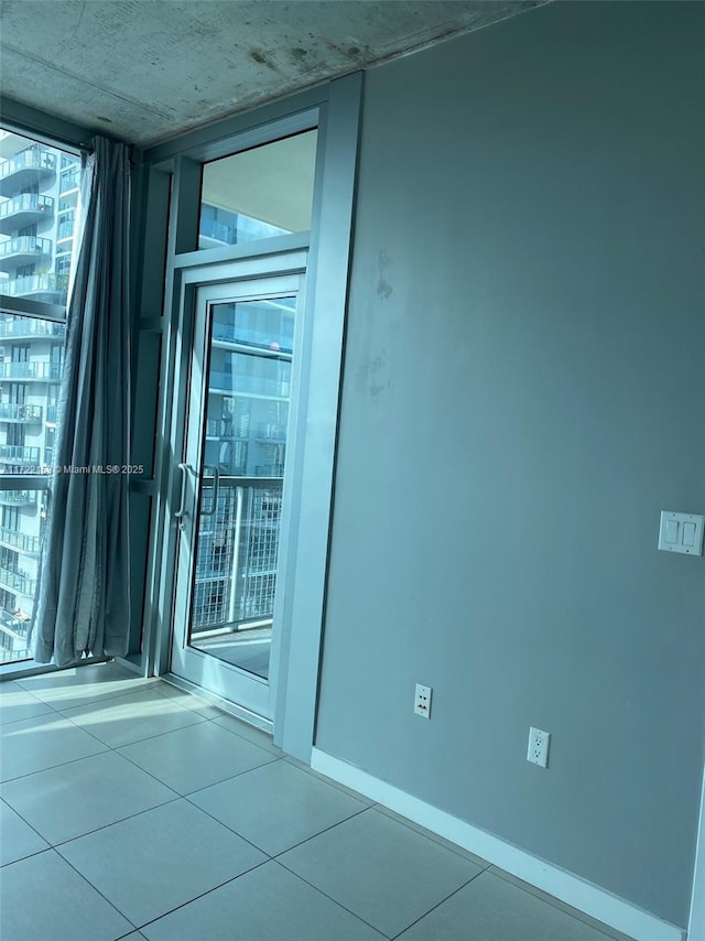 unfurnished room featuring tile patterned floors and expansive windows