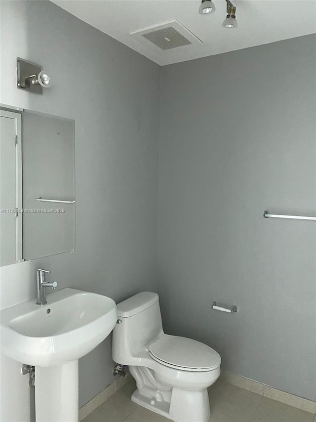 bathroom with tile patterned floors, toilet, and sink