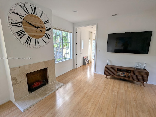 living room featuring hardwood / wood-style floors and a tile fireplace