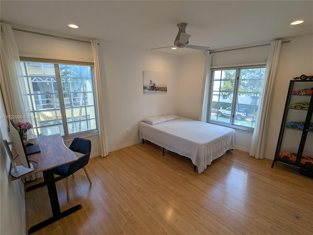 bedroom with ceiling fan and light hardwood / wood-style flooring