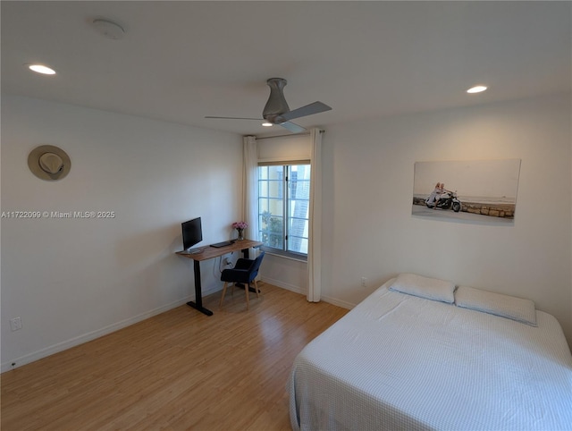 bedroom with ceiling fan and light hardwood / wood-style flooring