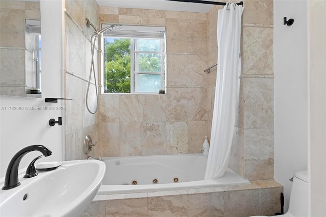 full bathroom featuring toilet, shower / tub combo with curtain, and sink