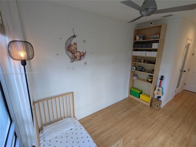 bedroom with ceiling fan and wood-type flooring