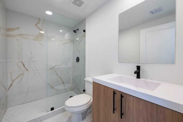 bathroom with vanity, toilet, and a tile shower