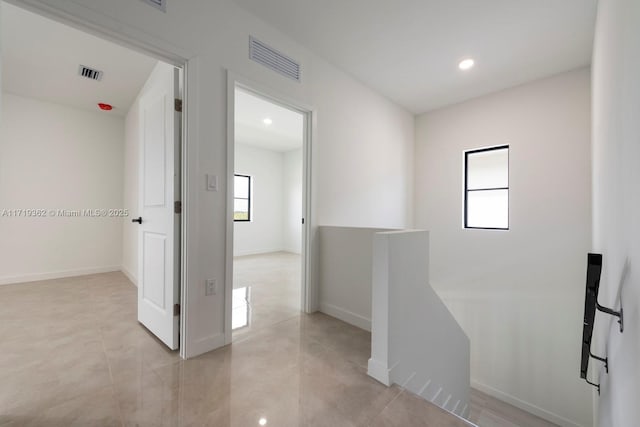 hall with light tile patterned floors