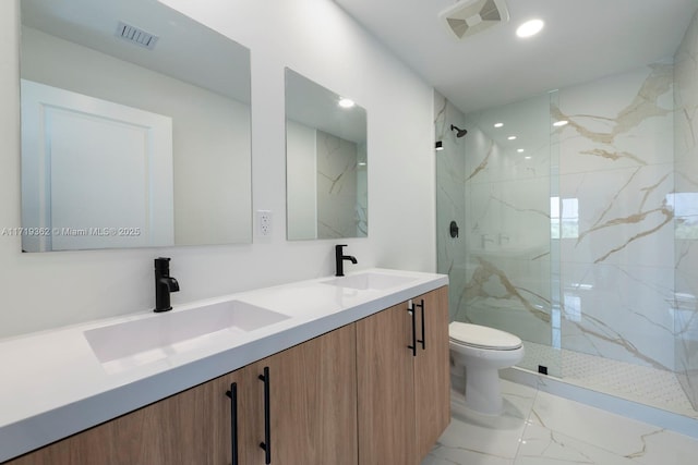 bathroom featuring vanity, toilet, and tiled shower