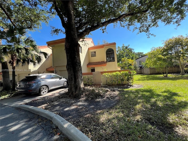 mediterranean / spanish-style house with a front lawn