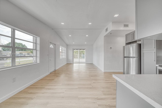 interior space with vaulted ceiling and light wood-type flooring