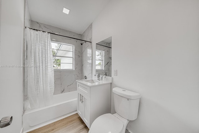 full bathroom featuring hardwood / wood-style flooring, vanity, toilet, and shower / bath combo with shower curtain