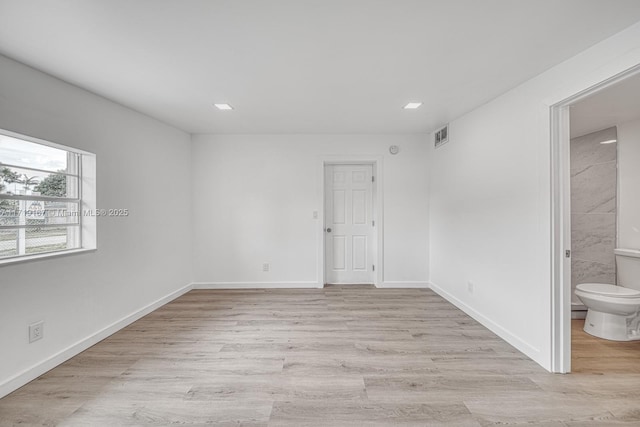 unfurnished room with light hardwood / wood-style floors