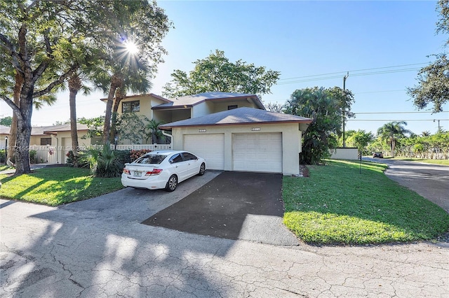 view of front facade featuring a garage and a front lawn