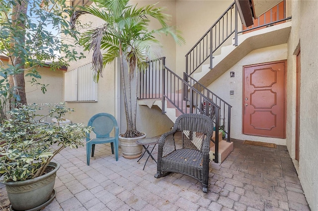 doorway to property with a patio area and stucco siding