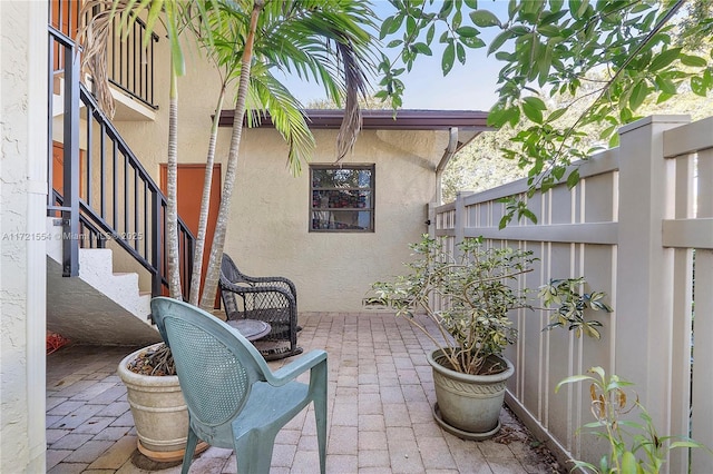 view of patio with stairway and a fenced backyard