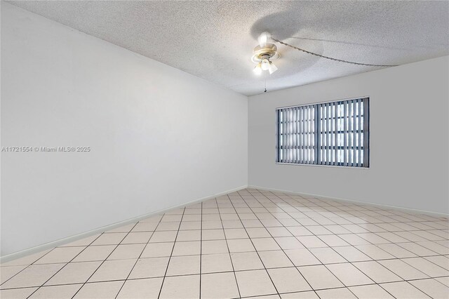 empty room with a textured ceiling and ceiling fan