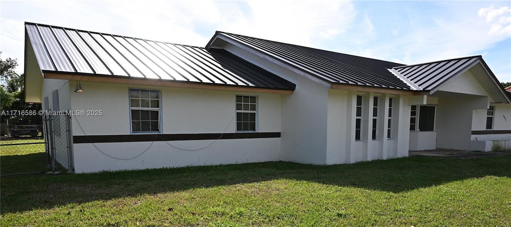 view of side of home featuring a lawn