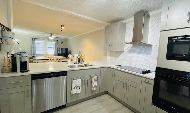 kitchen featuring sink, a textured ceiling, wall chimney range hood, crown molding, and black appliances